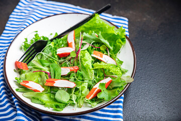 crab stick salad green lettuce leaves mix fresh meal snack on the table copy space food background rustic. top view keto or paleo diet 