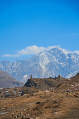 In a mountain valley, a breathtaking landscape of giant covered mountains in the background