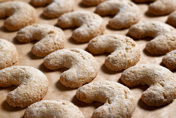 Crescent-shaped Christmas cookies on the baking sheet (vanilla crescents)