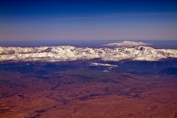 Red dust and snow covered mountains Atlas in Morocco