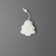 Fluffy white fur tree on a gray background. Top view