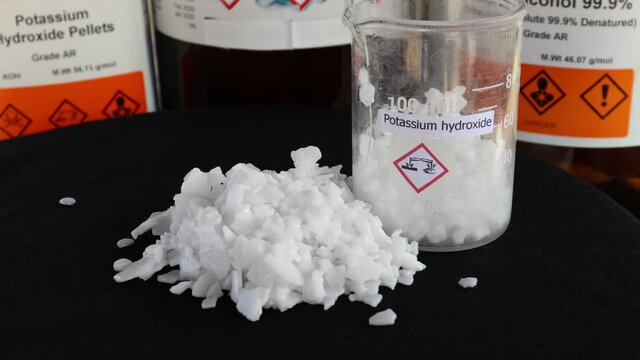Potassium hydroxide flake on black background, chemistry in the laboratory