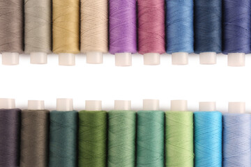 Set of colorful sewing threads on white background, flat lay. Space for text