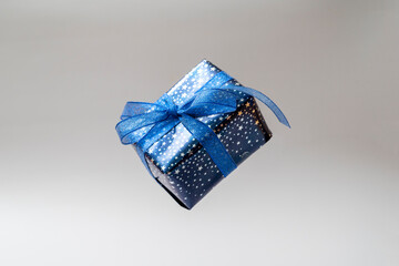 Gift blue box with blue bow. Christmas sinlge gift box isolated.