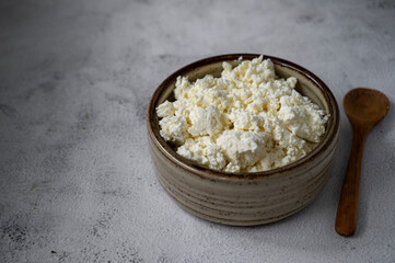 Cottage cheese in rustic bowl, healthy food, dairy product concept