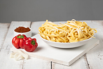 Fresh noodles on white table, copy space