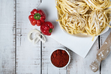 Fresh noodles on white table, copy space