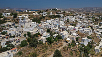 Fototapeta na wymiar Aerial drone photo of beautiful whitewashed village of Tripiti built uphill with great views to Aegean sea and main village of Milos island, Cyclades, Greece