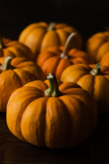 Small Pumpkins on a Table with Black Background