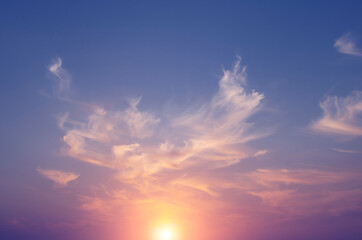 Fototapeta na wymiar Magical fabulous pink sunset and sun in soft clouds.