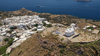 Aerial drone photo of main village of Plaka, main village of Milos island featuring uphill castle...
