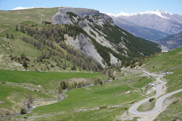 Fototapeta na wymiar landscape in the mountains in spring with meandering road up col de la bonette alps france