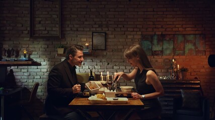 Stay at home and order food online - Couple having romantic dinner in home quarantine, eating from...
