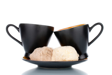 Two sweet cotton candy on a saucer with two cups, close-up, isolated on white.