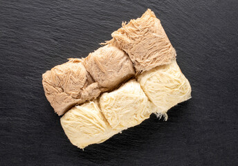 Several delicious cotton candy on a slate stone, close-up, top view.