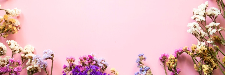 Flower composition. Banner. Frame made of dried multi-colored flowers. Flat lay, top view with place for text.