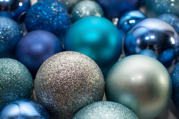 silver, blue and blue Christmas balls with blurred edges solid background