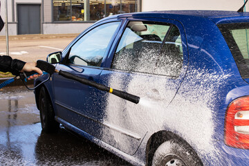 Blue car in foam at a car wash