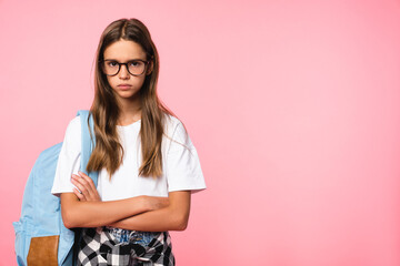 Offended sad angry young teenager girl schoolchild pupil with bag wearing glasses crossing her arms...