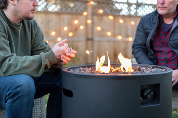Father and son having a fireside chat in the backyard