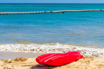 Red canoes at tropical beach panorama Playa del Carmen Mexico.