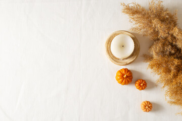 Autumn fla lay with dried pampas grass and pumpkins candle