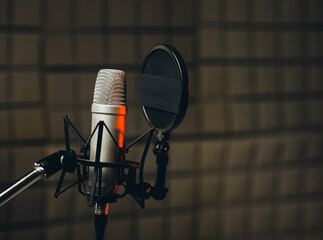 Pan shot of a professional microphone for dubbing and voice over in the sound recording studio....