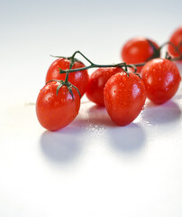 red cherry tomatoes close up on a white background 