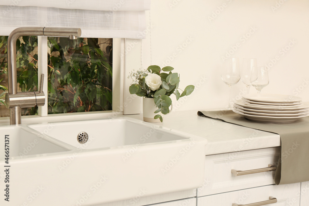 Sticker White sink with tap near window in kitchen. Interior design