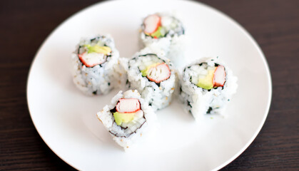 Five pieces of California sushi Rolls with crab and avocado and cucumbers. 