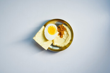 Food with place for text. Half a boiled egg with a beautiful yolk with mayonnaise and mustard with...