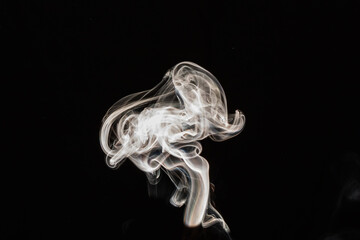 Smoke effect texture. Isolated background. Black and dark backdrop. Smokey fire and mistic effect.