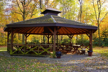 Wooden gazebo in autumn parks - relax and unwind.Soft focus