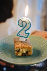 2 urodziny, świeczka na kawałku ciasta - obrazy, fototapety, plakaty