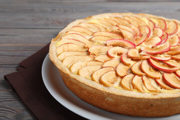 Freshly baked delicious apple pie on wooden table, closeup