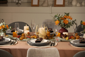 Table set with beautiful autumn decor for festive dinner in room