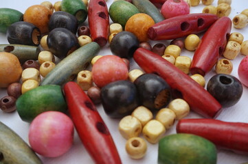 Colored Wooden Beads of Various Sizes on White Backgorund