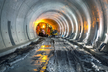 Excavator in construction place of building new railway tunnel. Railway corridor construction with...