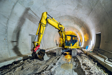 Excavator in construction place of building new railway tunnel. Railway corridor construction with...