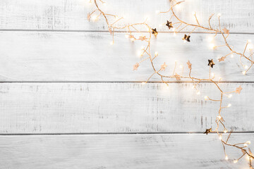 christmas garland lights on white wooden background