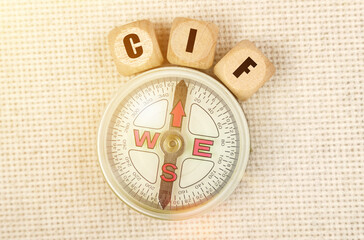 On the table is a compass and cubes with the inscription - CIF