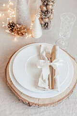 Festive christmas table setting with golden cutlery and porcelain plate and christmas decoration....