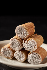 stack of cubanitos with dulce de leche and grated coconut. Cuchufli