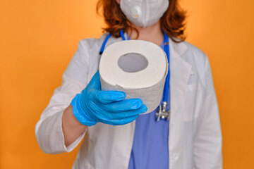 A nurse holds two rolls of white toilet paper. Doctor with a stethoscope with rolls of toilet paper in his hands, diarrhea concept.