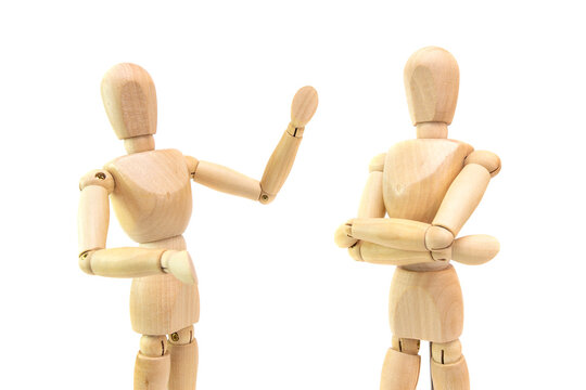 two wooden figures of people communicate