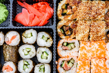Set of the different sushi in a plastic box. Top view