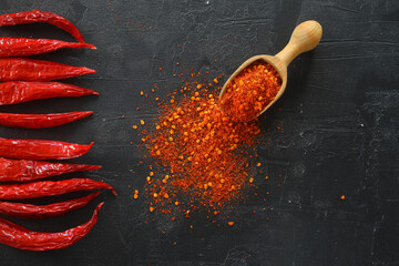 cayenne pepper on wooden spoon spices and dried chilli peppers background / group of red hot chilli...