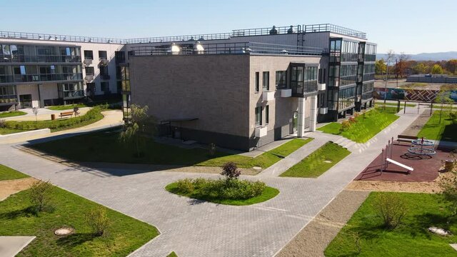 The camera peels off from a residential building through a closed courtyard. New microdistrict in the suburbs of Vladivostok. View from above.
