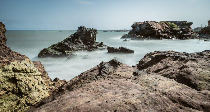 Waves Coming Towards The Beach And Meeting The Cliffs Of Ghana West Africa.