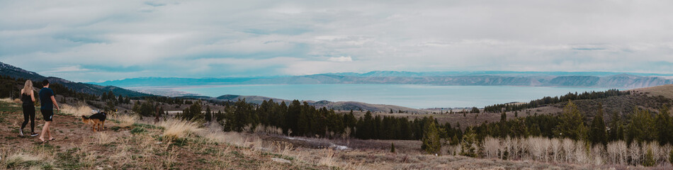 people looking at a mountain lake